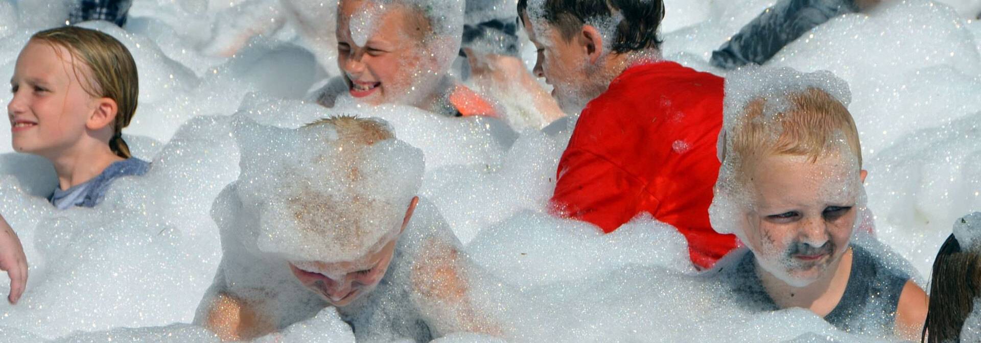 Children covered in foam at Madison County Fair event